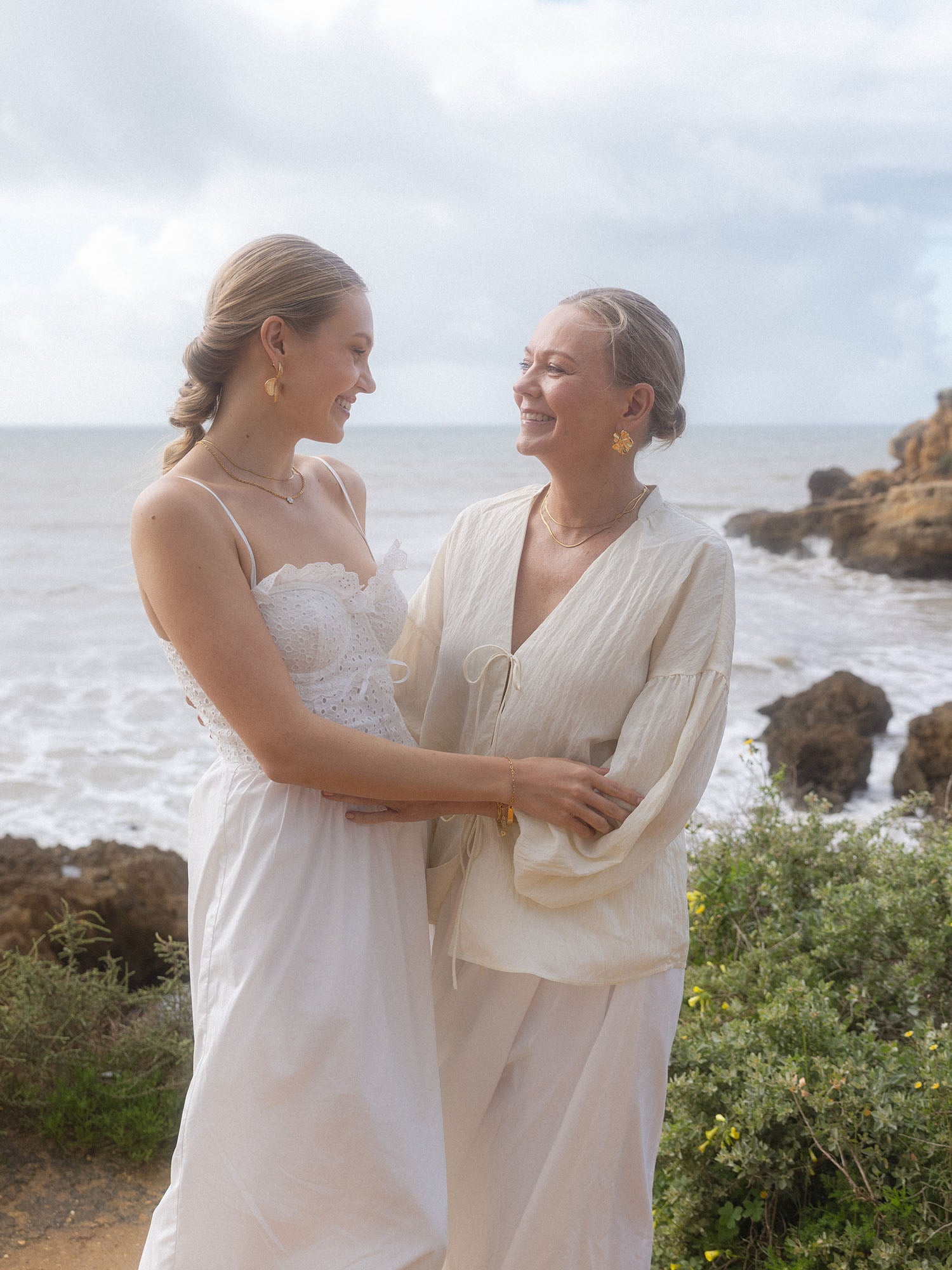 PURELEI Floral Ohrringe in vergoldetem Edelstahl mit floralem Design, natürlich und elegant am Strand getragen.